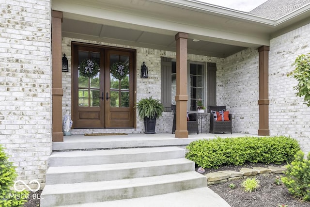 7648 Killarney Dr, Indianapolis, IN 46217 - property entrance featuring french doors, a porch, and brick siding