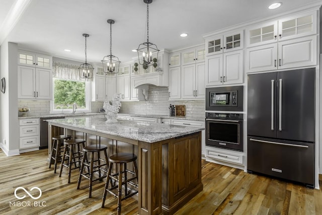 7648 Killarney Dr, Indianapolis, IN 46217 - kitchen with black appliances, a chandelier, white cabinetry, dark wood-type flooring, and recessed lighting