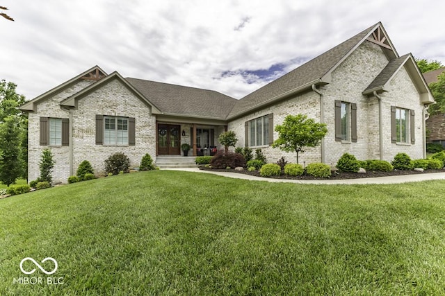 7648 Killarney Dr, Indianapolis, IN 46217 - view of front of home featuring brick siding, a front yard, and a shingled roof