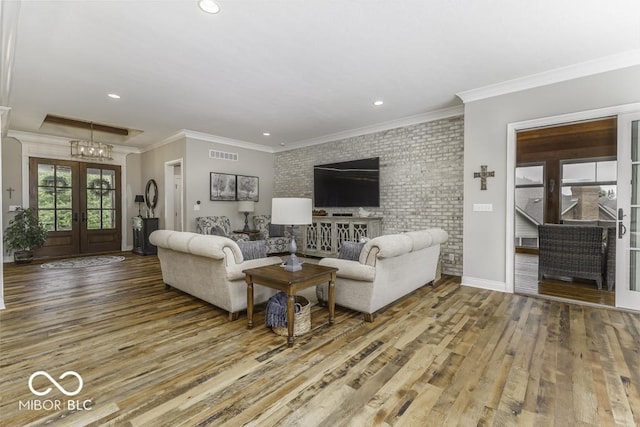 7648 Killarney Dr, Indianapolis, IN 46217 - living room featuring wood finished floors, french doors, a chandelier, recessed lighting, and crown molding