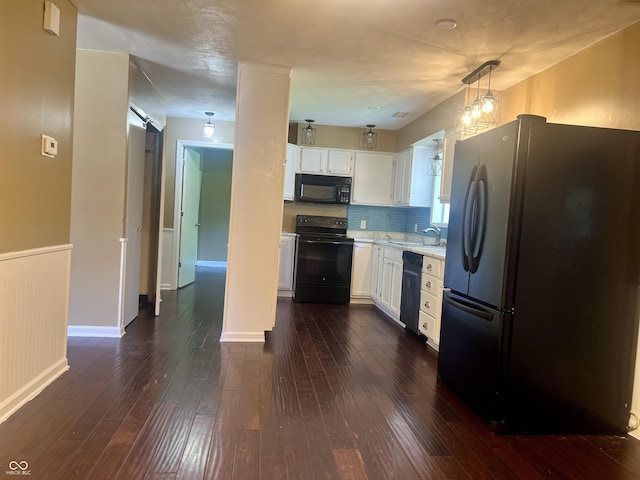 7824 Hearthstone Way, Indianapolis, IN 46227 - kitchen featuring black appliances, a sink, light countertops, white cabinetry, and a wainscoted wall