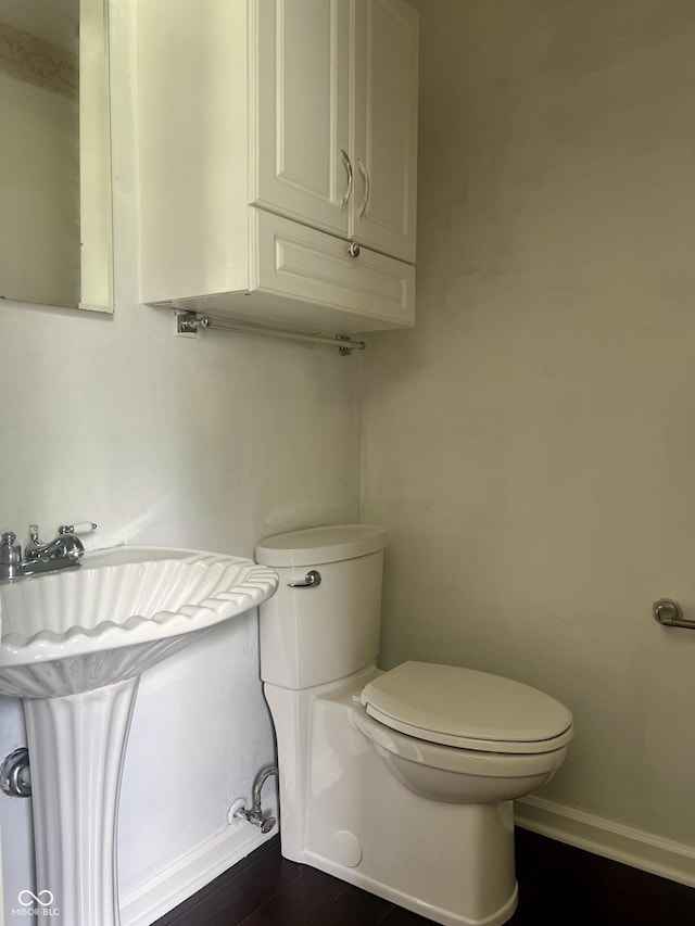 7824 Hearthstone Way, Indianapolis, IN 46227 - bathroom with toilet, wood finished floors, baseboards, and a sink