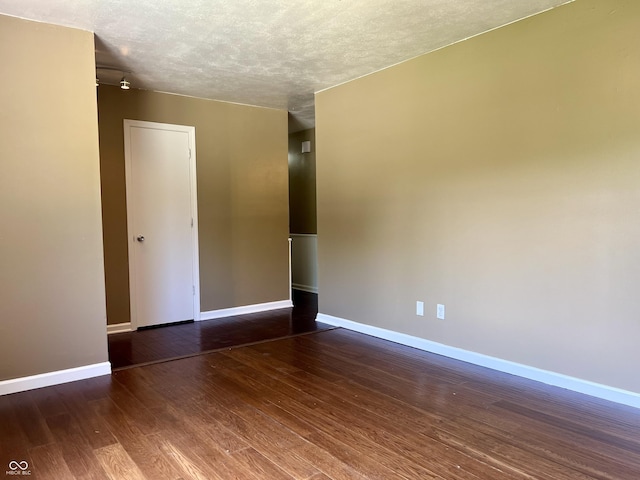 7824 Hearthstone Way, Indianapolis, IN 46227 - unfurnished room featuring baseboards, hardwood / wood-style flooring, and a textured ceiling