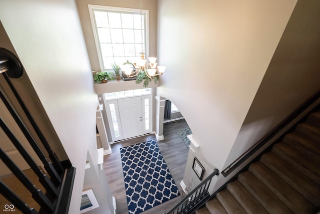 12093 Ashland Dr, Fishers, IN 46037 - entryway featuring stairs, wood finished floors, a chandelier, and arched walkways