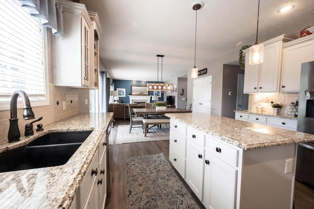 12093 Ashland Dr, Fishers, IN 46037 - kitchen featuring dark wood finished floors, decorative backsplash, a center island, open floor plan, and recessed lighting