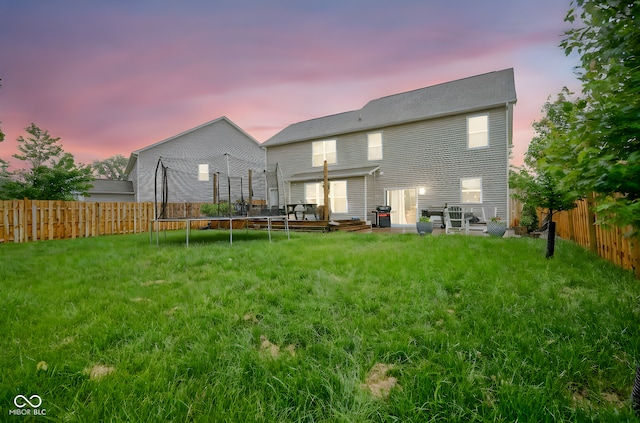 5374 John Quincy Adams Ct, Plainfield, IN 46168 - back of property at dusk with a wooden deck and a trampoline