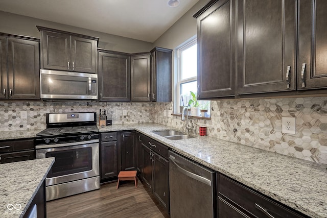 5374 John Quincy Adams Ct, Plainfield, IN 46168 - kitchen with stainless steel appliances, a sink, dark brown cabinetry, and dark wood-type flooring