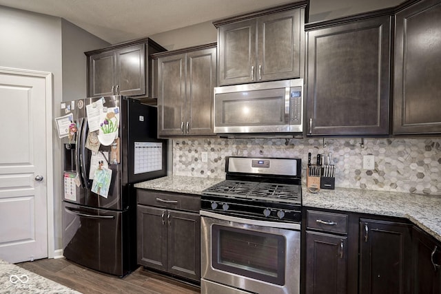 5374 John Quincy Adams Ct, Plainfield, IN 46168 - kitchen featuring appliances with stainless steel finishes, dark brown cabinets, and backsplash