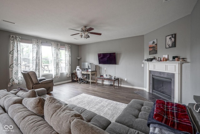 5374 John Quincy Adams Ct, Plainfield, IN 46168 - living room featuring baseboards, a ceiling fan, wood finished floors, a tile fireplace, and a textured ceiling