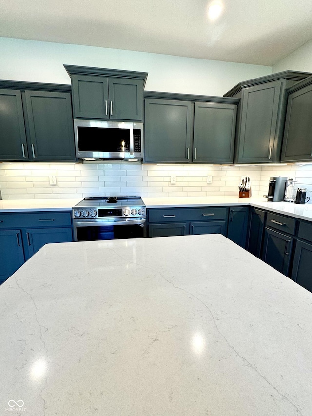252 Patriots Lndg, Fillmore, IN 46128 - kitchen featuring appliances with stainless steel finishes, tasteful backsplash, and light stone countertops