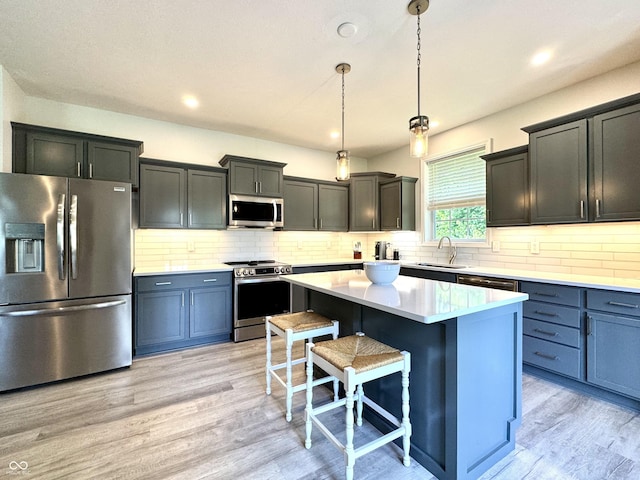 252 Patriots Lndg, Fillmore, IN 46128 - kitchen featuring stainless steel appliances, a kitchen bar, tasteful backsplash, pendant lighting, and a kitchen island