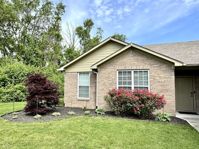 252 Patriots Lndg, Fillmore, IN 46128 - view of home's exterior with brick siding, a yard, and a shingled roof