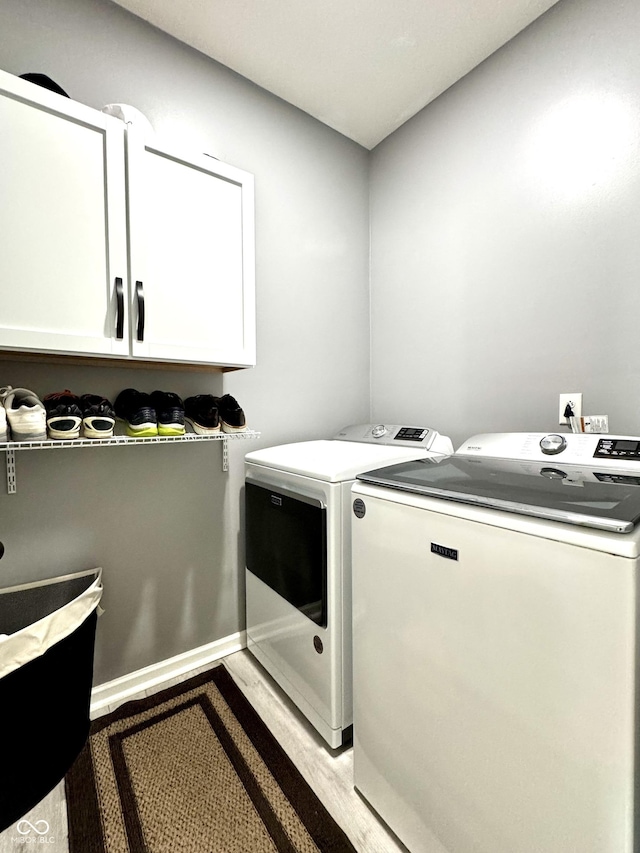 252 Patriots Lndg, Fillmore, IN 46128 - laundry area featuring cabinet space, washing machine and clothes dryer, and light wood finished floors