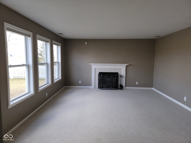 11754 Hamble Dr, Indianapolis, IN 46235 - unfurnished living room with healthy amount of natural light, a fireplace, and light colored carpet