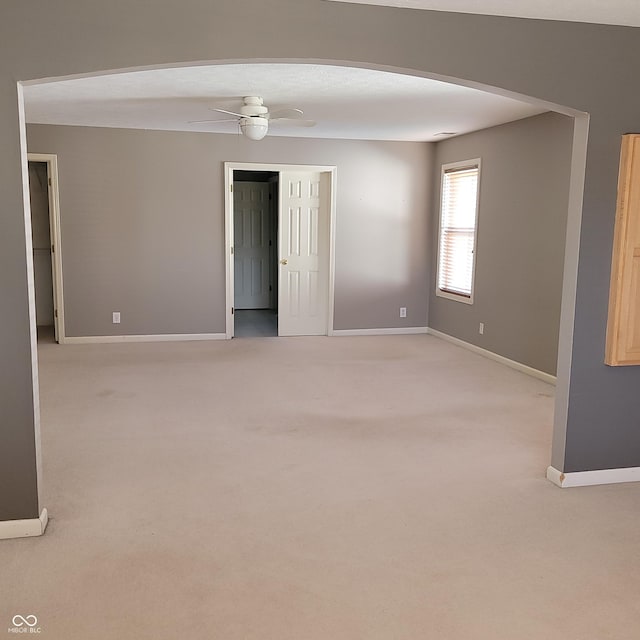 11754 Hamble Dr, Indianapolis, IN 46235 - unfurnished room with light carpet, arched walkways, and a ceiling fan