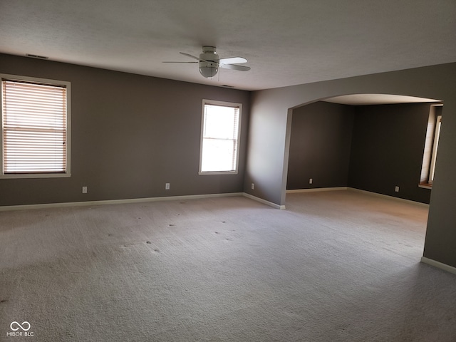 11754 Hamble Dr, Indianapolis, IN 46235 - unfurnished room featuring arched walkways, a ceiling fan, and light carpet