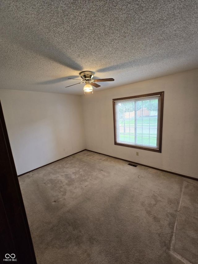 1805 River Run Trl, Fort Wayne, IN 46825 - spare room featuring light colored carpet, ceiling fan, and a textured ceiling
