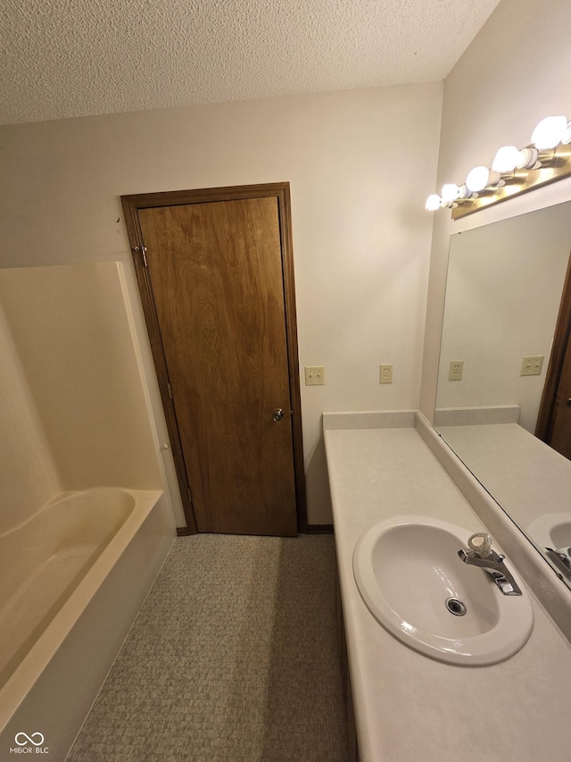 1805 River Run Trl, Fort Wayne, IN 46825 - bathroom with a bathtub, a textured ceiling, and vanity