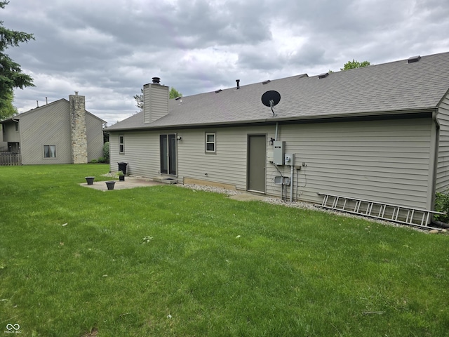 1805 River Run Trl, Fort Wayne, IN 46825 - rear view of property featuring a patio, a yard, a chimney, and roof with shingles