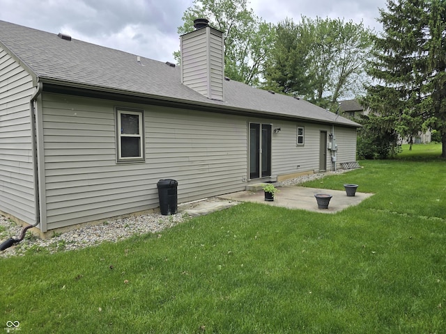 1805 River Run Trl, Fort Wayne, IN 46825 - back of house with a lawn, a patio, a shingled roof, and a chimney