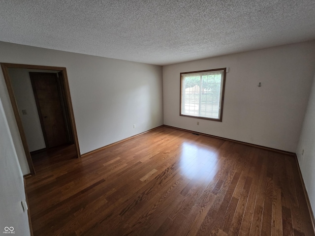 1805 River Run Trl, Fort Wayne, IN 46825 - spare room with wood finished floors, a textured ceiling, and baseboards
