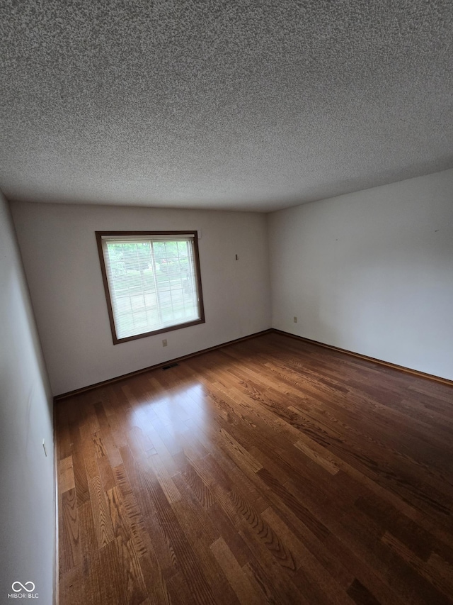 1805 River Run Trl, Fort Wayne, IN 46825 - unfurnished room featuring wood finished floors, a textured ceiling, and baseboards