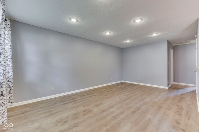 521 Elmhurst Pl, Whiteland, IN 46184 - unfurnished room featuring a textured ceiling, light wood-style floors, baseboards, and recessed lighting