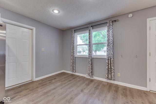 521 Elmhurst Pl, Whiteland, IN 46184 - spare room with a textured ceiling, wood finished floors, baseboards, and a smoke detector