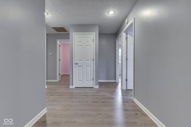 521 Elmhurst Pl, Whiteland, IN 46184 - corridor with a textured ceiling, baseboards, and light wood finished floors