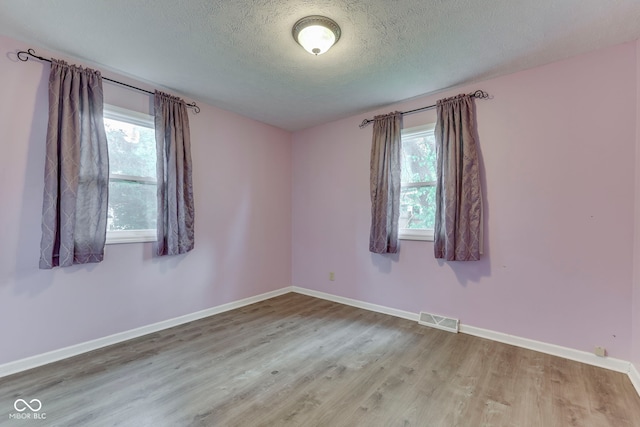 521 Elmhurst Pl, Whiteland, IN 46184 - empty room with wood finished floors, a textured ceiling, and baseboards