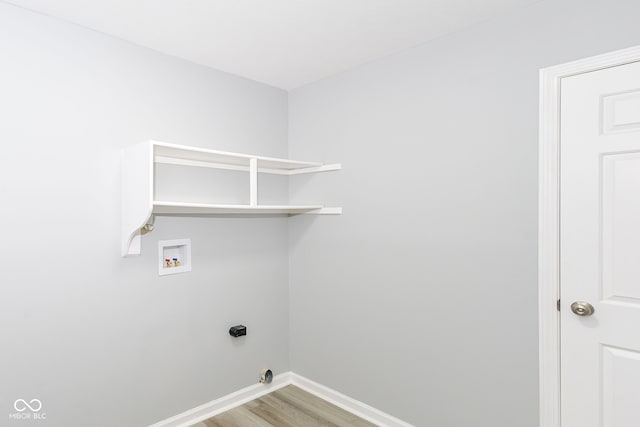 12289 Charing Cross Rd, Carmel, IN 46033 - laundry room with baseboards, hookup for a washing machine, and light wood-style flooring