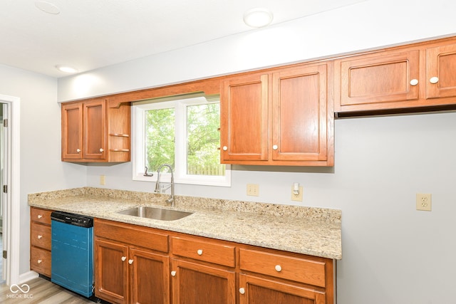 12289 Charing Cross Rd, Carmel, IN 46033 - kitchen featuring a sink, dishwasher, light stone counters, light wood-style floors, and brown cabinets