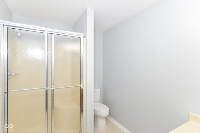 12289 Charing Cross Rd, Carmel, IN 46033 - full bath with toilet, a stall shower, baseboards, and tile patterned floors