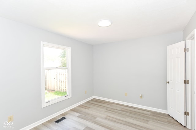 12289 Charing Cross Rd, Carmel, IN 46033 - unfurnished room with light wood-type flooring, healthy amount of natural light, and baseboards