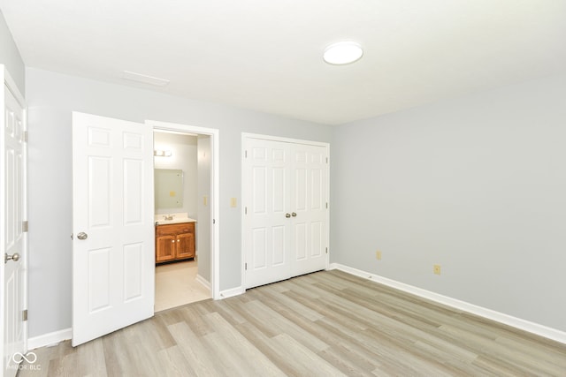 12289 Charing Cross Rd, Carmel, IN 46033 - unfurnished bedroom with light wood-style floors, a closet, baseboards, and ensuite bathroom