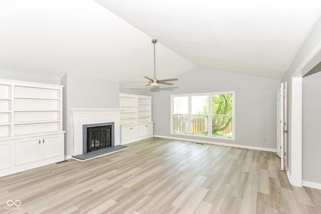 12289 Charing Cross Rd, Carmel, IN 46033 - unfurnished living room with ceiling fan, a fireplace with raised hearth, light wood finished floors, lofted ceiling, and baseboards
