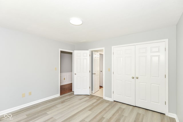 12289 Charing Cross Rd, Carmel, IN 46033 - unfurnished bedroom with light wood-style floors, a closet, and baseboards