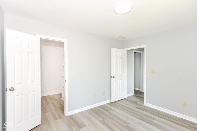 12289 Charing Cross Rd, Carmel, IN 46033 - unfurnished bedroom with light wood-style flooring and baseboards
