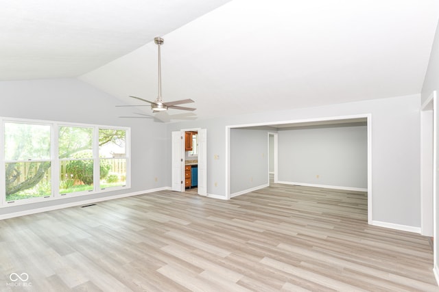 12289 Charing Cross Rd, Carmel, IN 46033 - unfurnished living room with a ceiling fan, light wood finished floors, lofted ceiling, and baseboards