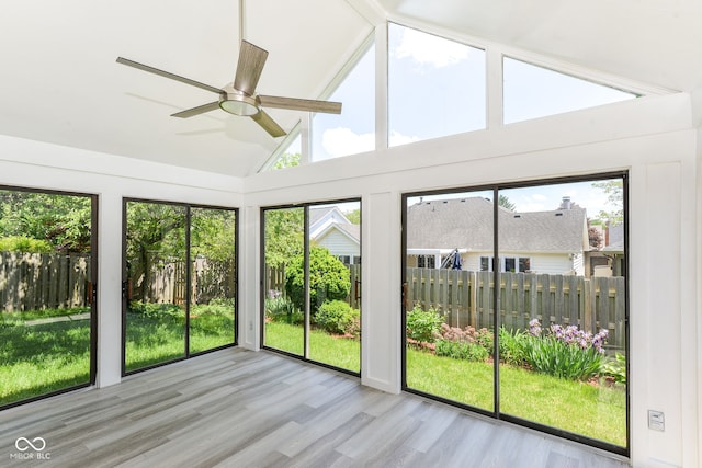 12289 Charing Cross Rd, Carmel, IN 46033 - unfurnished sunroom with wood finished floors, high vaulted ceiling, and plenty of natural light