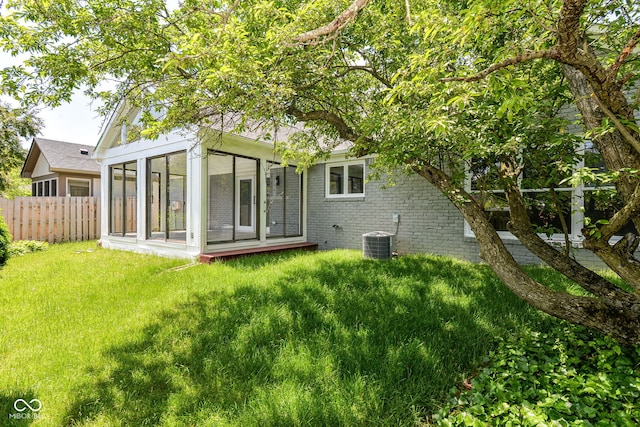 12289 Charing Cross Rd, Carmel, IN 46033 - back of house with a sunroom, central air condition unit, and brick siding
