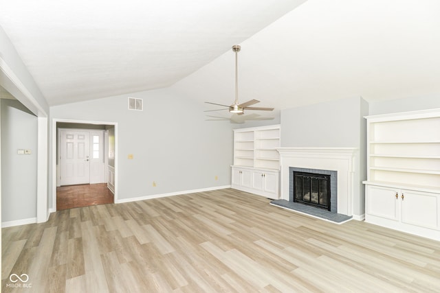 12289 Charing Cross Rd, Carmel, IN 46033 - unfurnished living room featuring a ceiling fan, a brick fireplace, light wood finished floors, vaulted ceiling, and baseboards