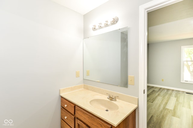 12289 Charing Cross Rd, Carmel, IN 46033 - bathroom featuring vanity, wood finished floors, and baseboards