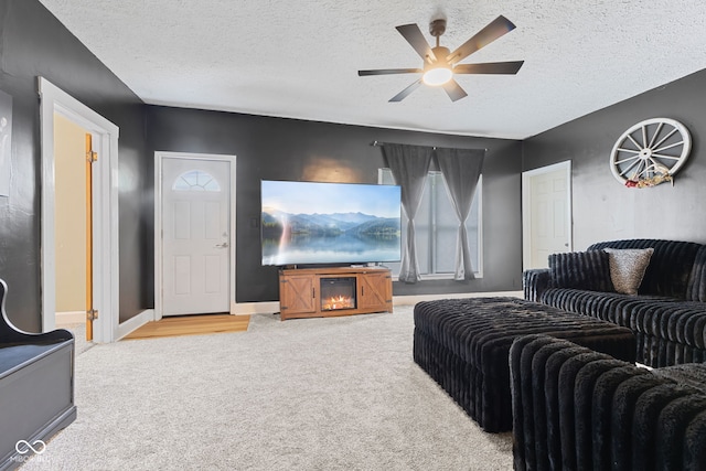 5594 S County Road 550 E, Greencastle, IN 46135 - carpeted living room with a textured ceiling, ceiling fan, and baseboards