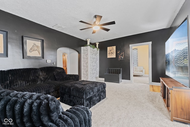 5594 S County Road 550 E, Greencastle, IN 46135 - carpeted living area featuring a ceiling fan, arched walkways, baseboards, and a textured ceiling