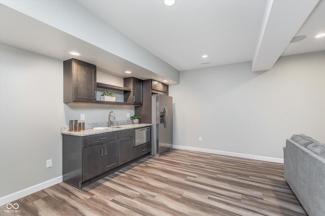 16071 Prince Ct, Noblesville, IN 46062 - kitchen with appliances with stainless steel finishes, open shelves, a sink, baseboards, and light wood-type flooring