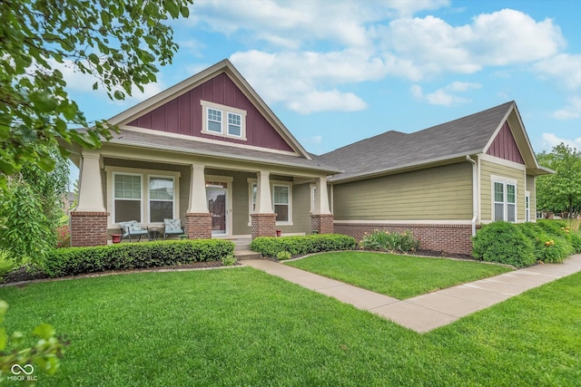 16071 Prince Ct, Noblesville, IN 46062 - craftsman house featuring brick siding, covered porch, board and batten siding, and a front lawn