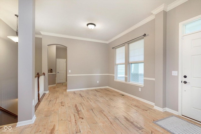 16071 Prince Ct, Noblesville, IN 46062 - entrance foyer with light wood-style flooring, arched walkways, ornamental molding, and baseboards