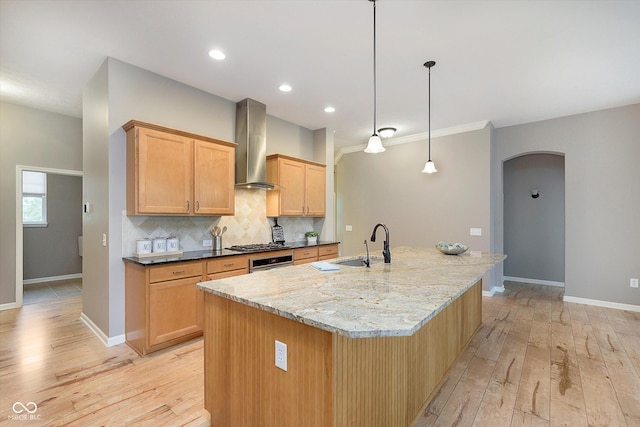 16071 Prince Ct, Noblesville, IN 46062 - kitchen featuring range hood, arched walkways, a sink, light wood-style floors, and baseboards