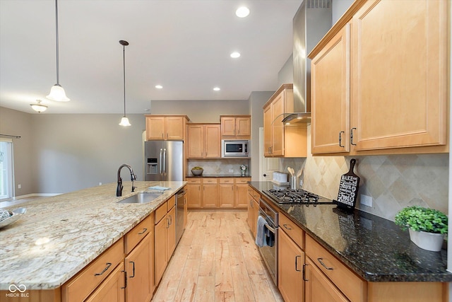 16071 Prince Ct, Noblesville, IN 46062 - kitchen featuring stainless steel appliances, a sink, light wood finished floors, wall chimney exhaust hood, and light brown cabinetry